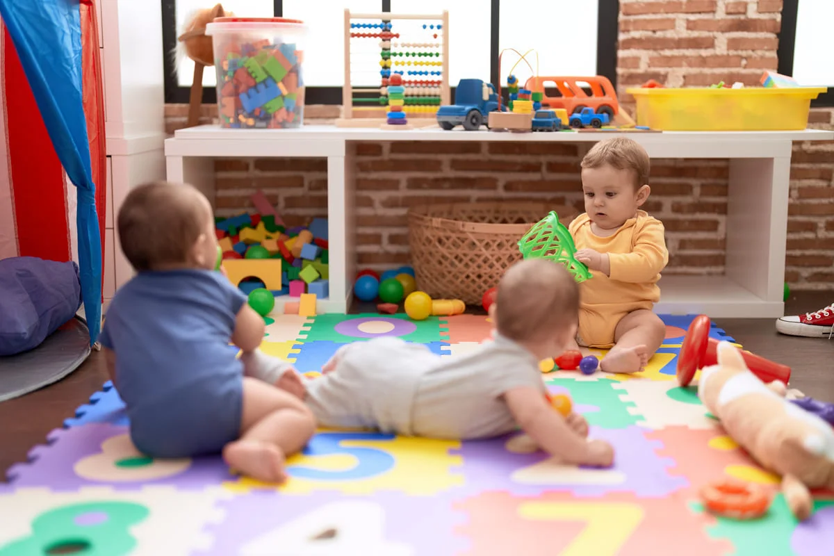 grupo crianças brincando com brinquedos chão rastejante jardim de infância